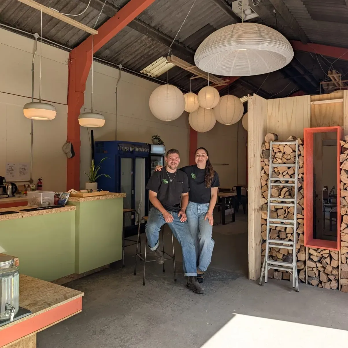 The main space now: bar, pendant lights and a full log store