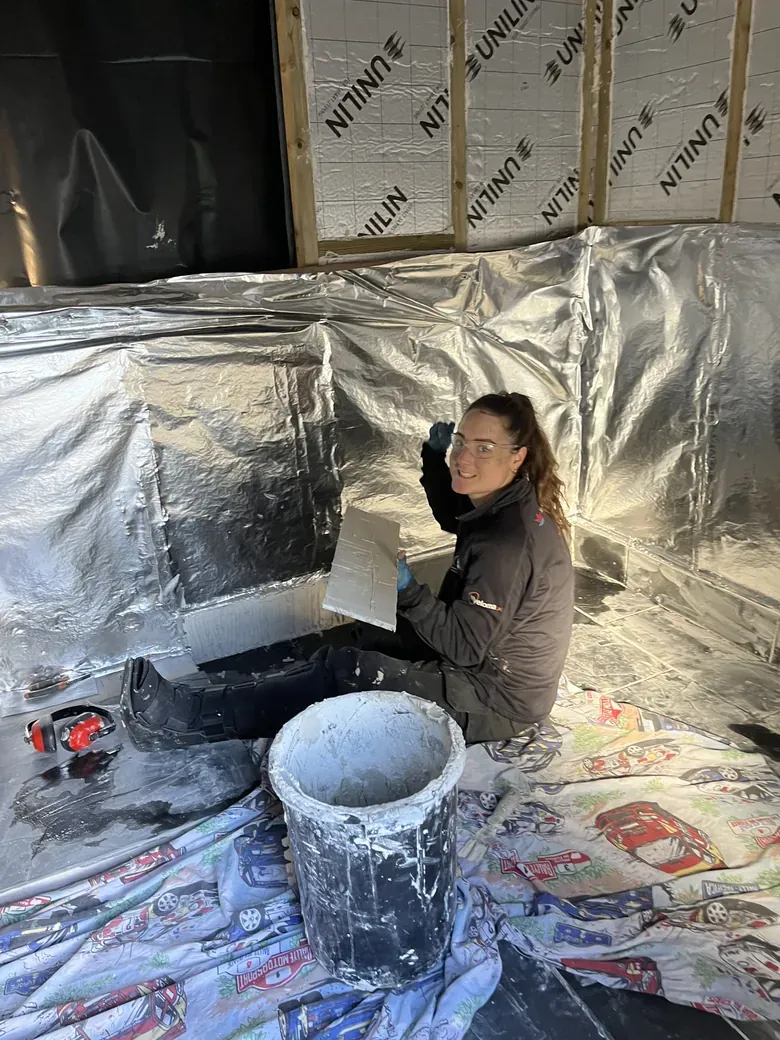 Tiling with her boot on!